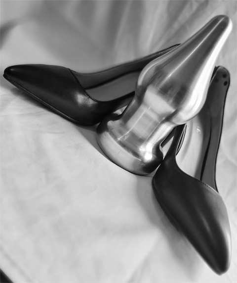 anal plug high heels Black silicone anal plug and high heel shoes on a red background stock  photo images. Set main image 0